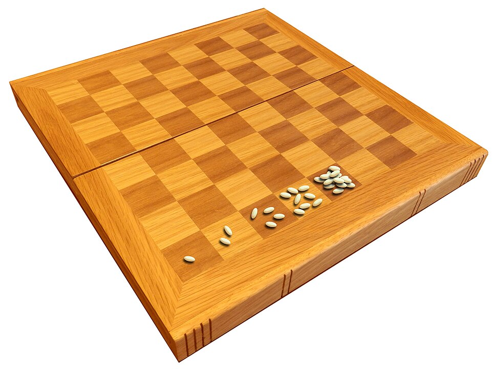Grains of wheat being placed on a chessboard, doubling with each subsequent square